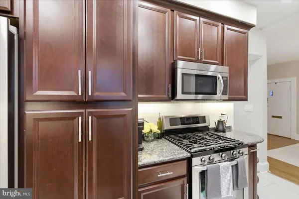 a kitchen with granite countertop stainless steel appliances and cabinets