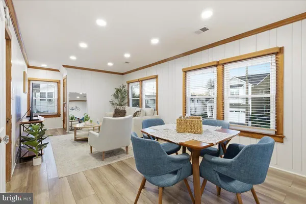 a living room with furniture and floor to ceiling windows