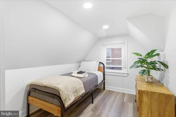 a bedroom with a bed and a potted plant