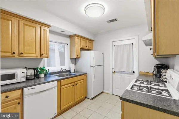 a kitchen with a stove and a refrigerator