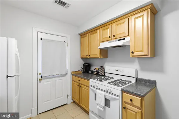 a kitchen with stainless steel appliances white cabinets and a stove