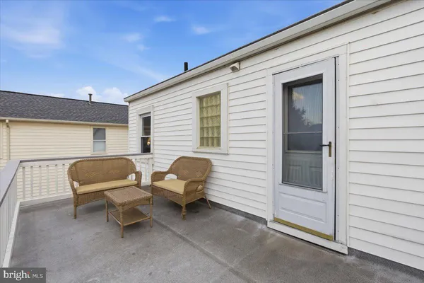 a backyard of a house with glass top table and chairs