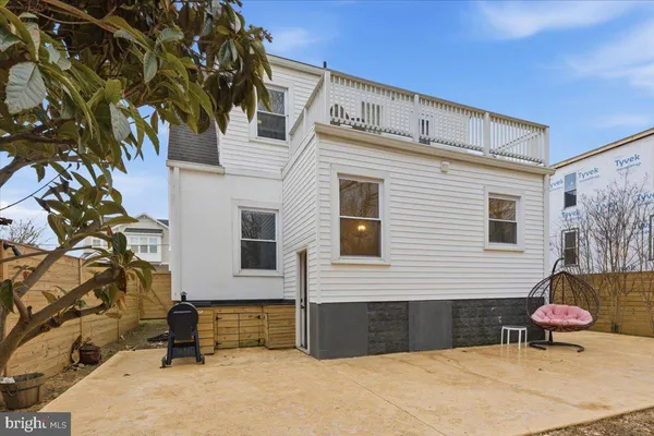 a view of a two chairs in the back yard
