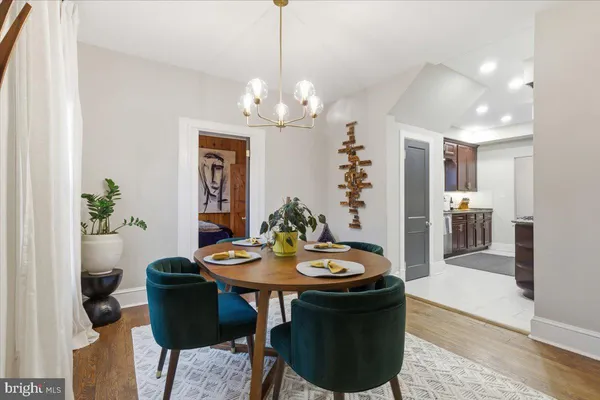 a view of a dining room with furniture and chandelier