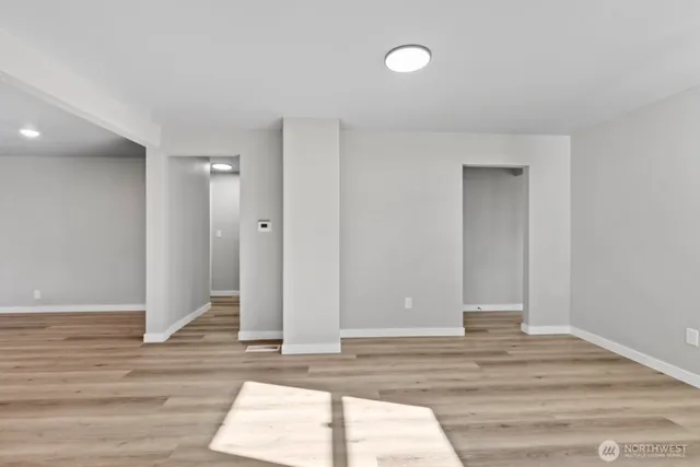 a view of room with window and wooden floor