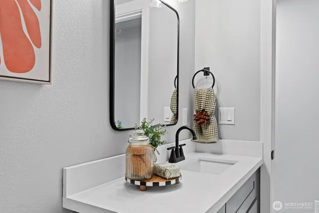 a bathroom with a sink and a mirror