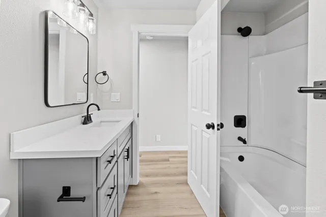 a bathroom with a sink a mirror and a bathtub