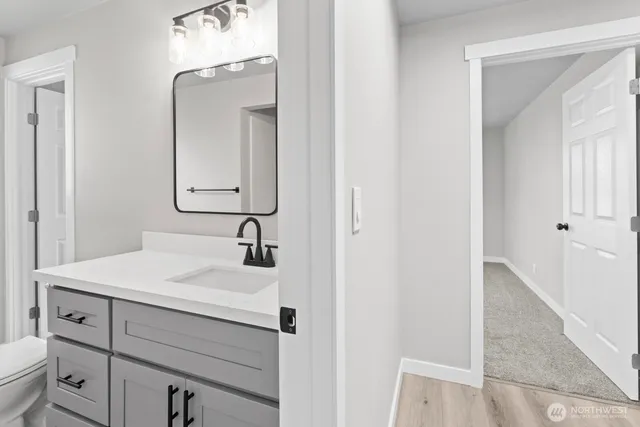 a bathroom with a sink vanity and a mirror