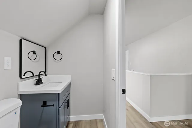 a bathroom with a sink a toilet and vanity