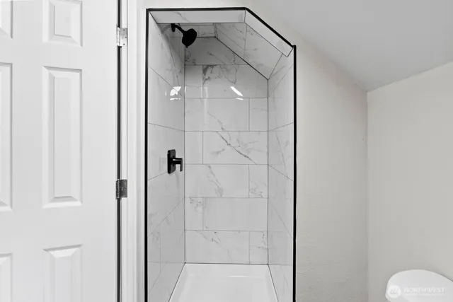 a bathroom that has a glass shower door