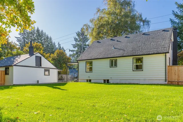 a view of a house with a yard patio and fire pit