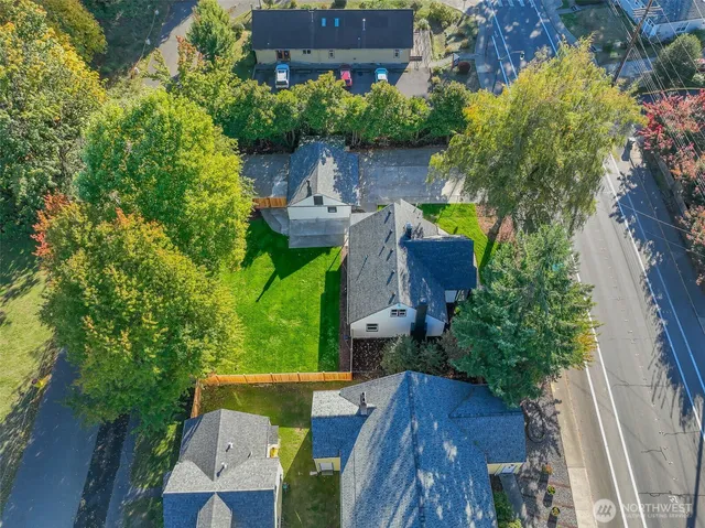 an aerial view of a house with garden space and street view