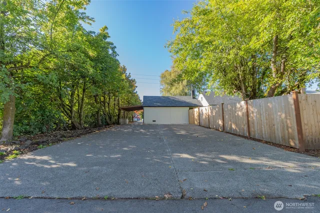 a view of a house with a tree and plants