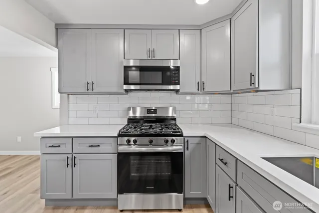 a kitchen with cabinets stainless steel appliances and wooden cabinets