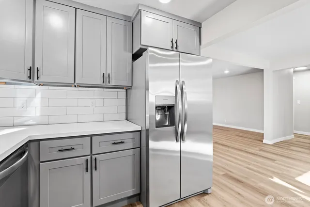 a kitchen with kitchen island a counter top space wooden floor and appliances