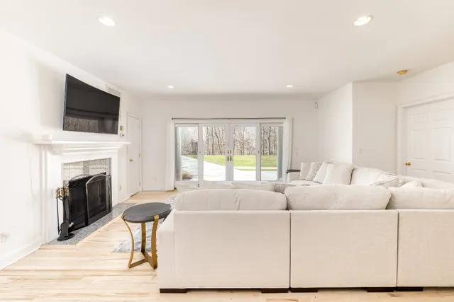 a living room with furniture a fireplace and a flat screen tv