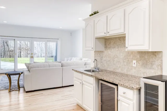 a kitchen with stainless steel appliances granite countertop a sink and a white cabinets