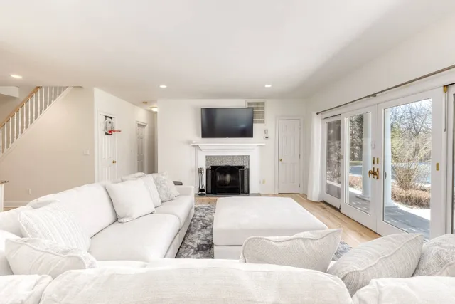 a living room with furniture fireplace and flat screen tv