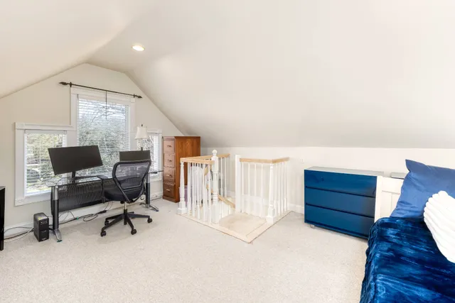 a view of a workspace with furniture and a window