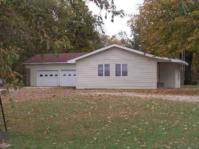 a view of a house with a yard and garage