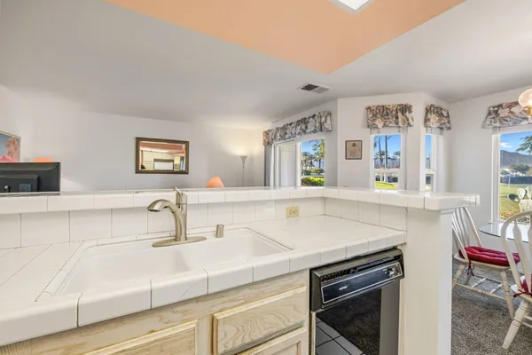 a kitchen with a stove sink and a refrigerator