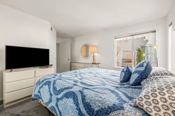 a bedroom with a bed and a window