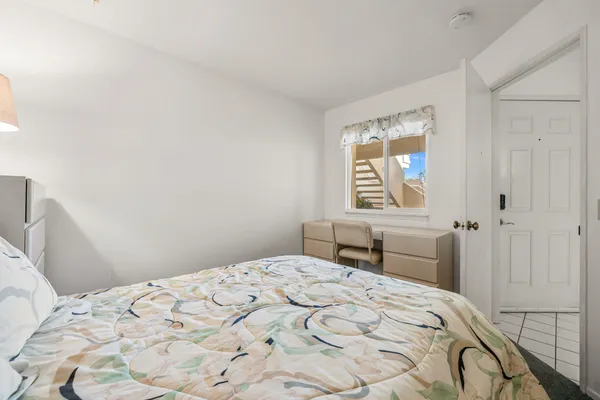 a bedroom with a bed and a window