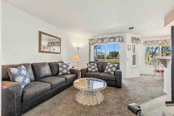 a living room with furniture and a large window