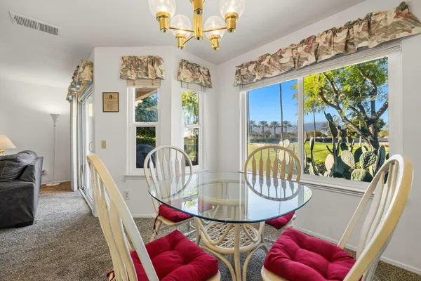 a view of a dining room with furniture window and outside view