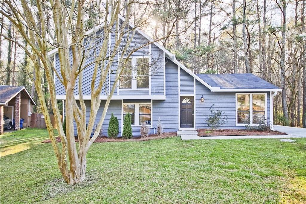 555 Utoy Circle Southwest Atlanta, GA 30331 - Photo 1 of 1 a front view of a house with garden