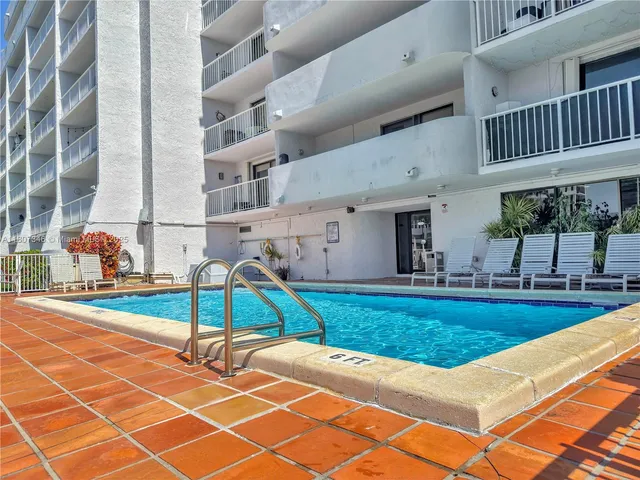 a view of a backyard with a table and chairs