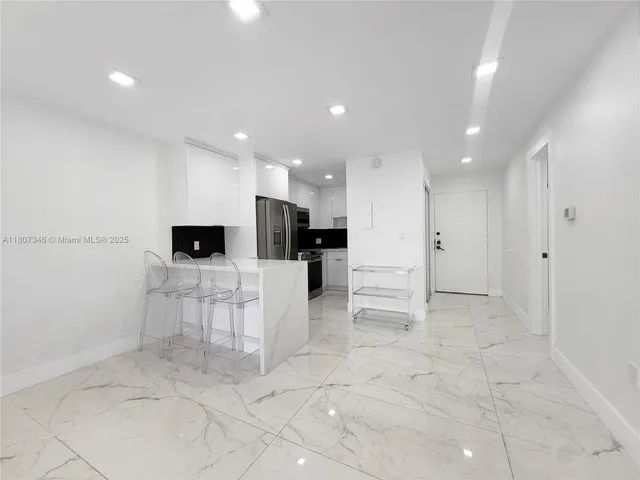 a view of kitchen with furniture and a refrigerator