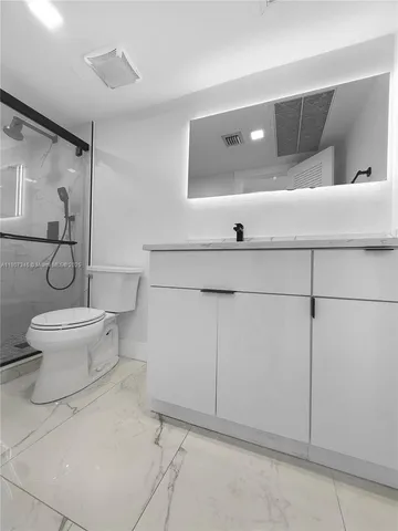a bathroom with a toilet and a shower