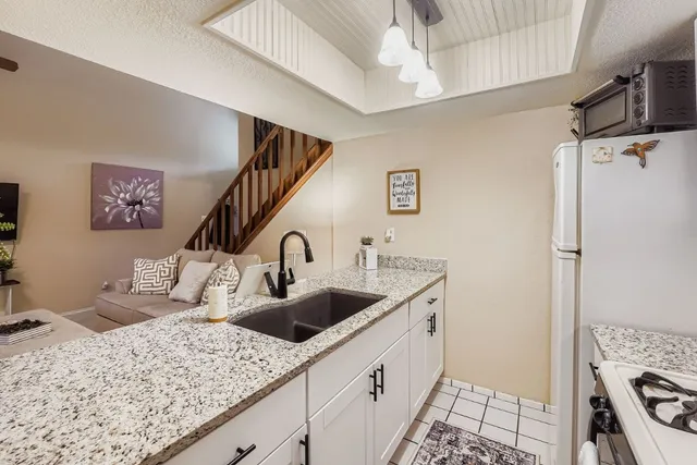 a kitchen with sink and refrigerator