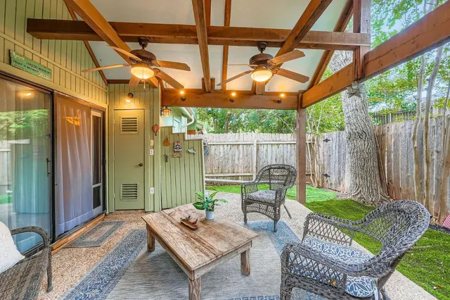 a backyard of a house with table and chairs