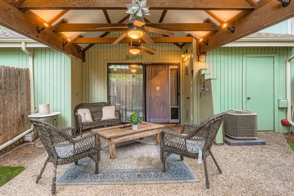 a outdoor living space with furniture and umbrella
