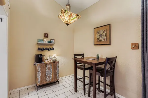a view of a dining room with furniture and chandelier