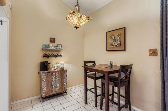 a view of a dining room with furniture and chandelier