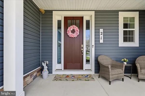 a view of a livingroom with wooden floor and staircase