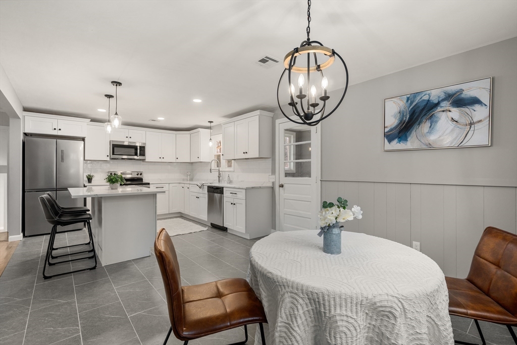 3 Mower Street Paxton, MA 01612 - Photo 21 of 36 a kitchen with a dining table chairs and white cabinets