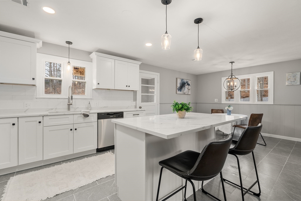 3 Mower Street Paxton, MA 01612 - Photo 22 of 36 a kitchen with white cabinets and chairs