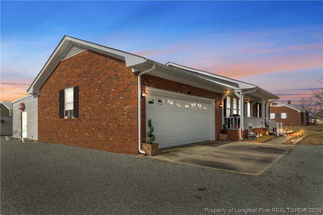 8571 Rhodes Pond Road Dunn, NC 28334 - Photo 1 of 18 a front view of a house with a garage
