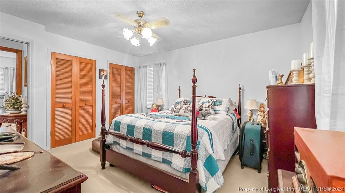 8571 Rhodes Pond Road Dunn, NC 28334 - Photo 12 of 18 a bed room with a bed and a chandelier