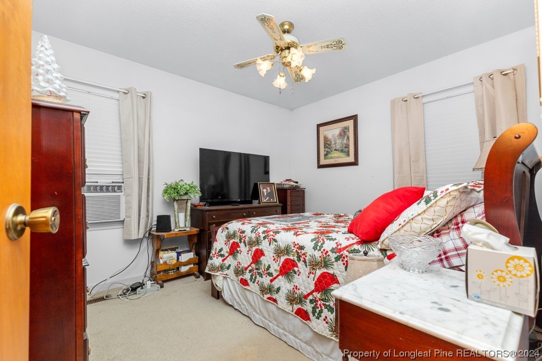 8571 Rhodes Pond Road Dunn, NC 28334 - Photo 13 of 18 a bedroom with bed and furniture