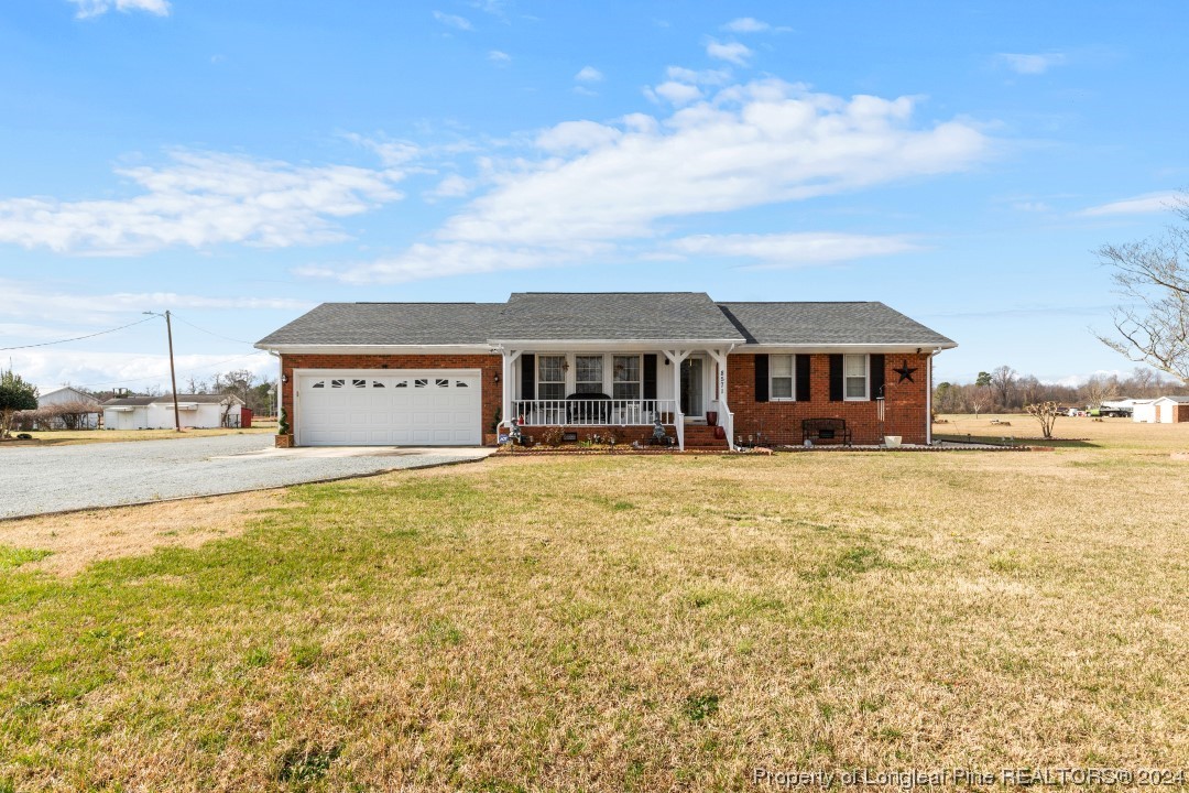 8571 Rhodes Pond Road Dunn, NC 28334 - Photo 3 of 18 a front view of a building with swimming pool