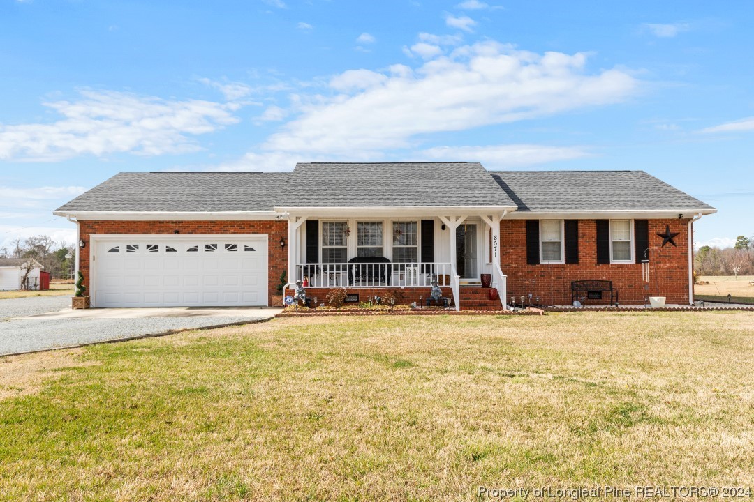8571 Rhodes Pond Road Dunn, NC 28334 - Photo 5 of 18 a view of a house with a swimming pool and a yard