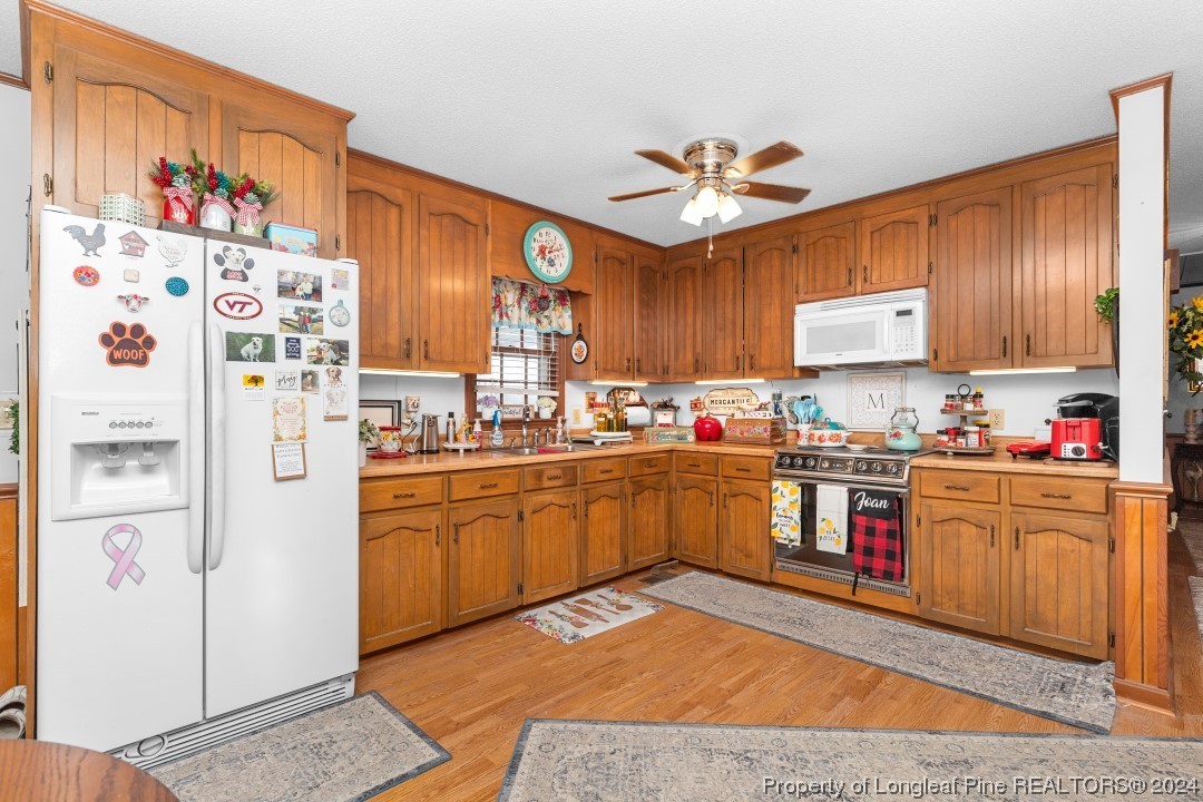 8571 Rhodes Pond Road Dunn, NC 28334 - Photo 8 of 18 a kitchen with stainless steel appliances granite countertop a refrigerator and a stove top oven