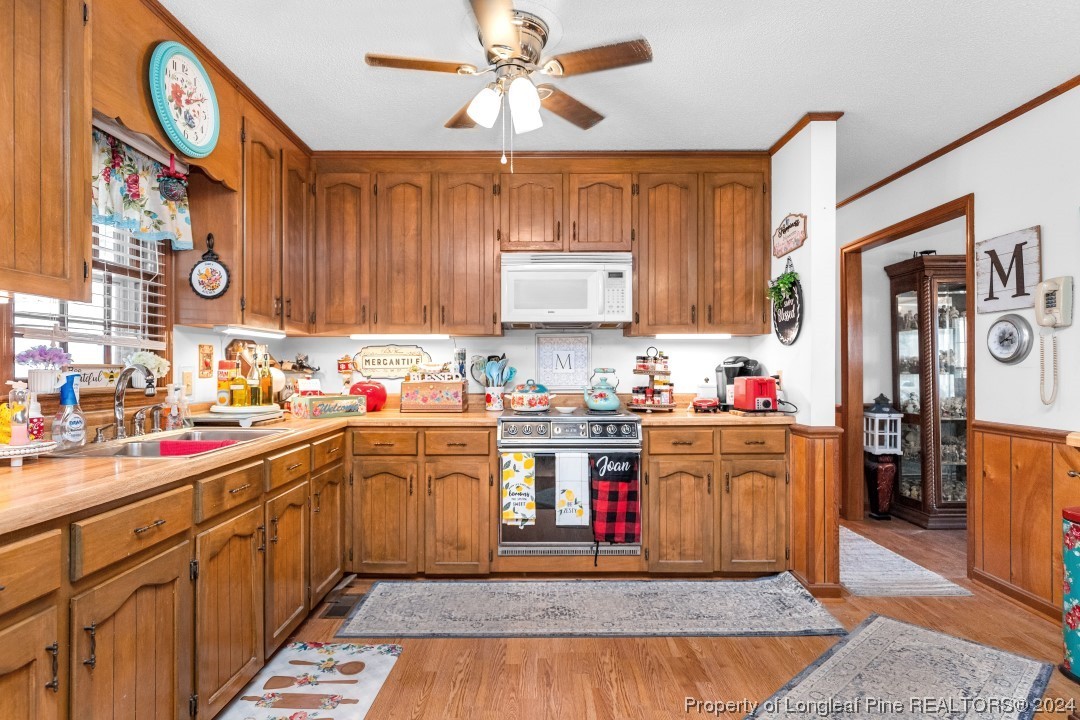 8571 Rhodes Pond Road Dunn, NC 28334 - Photo 10 of 18 a kitchen with stainless steel appliances granite countertop a stove sink and cabinets
