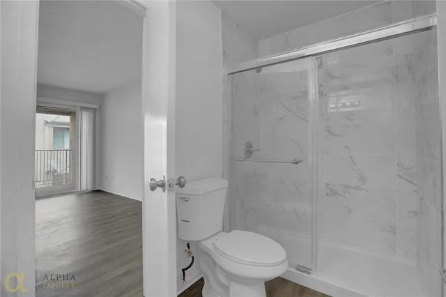 a bathroom with a shower and a toilet