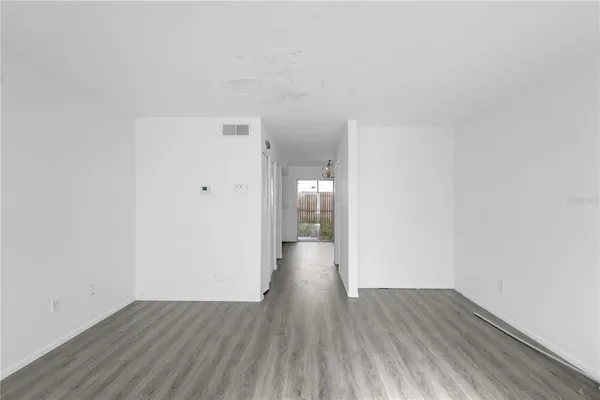 a view of an empty room and wooden floor